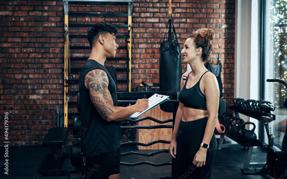 Canvas Prints Signup with us, you wont regret it. Shot of a sporty young woman talking to a fitness trainer at the gym.