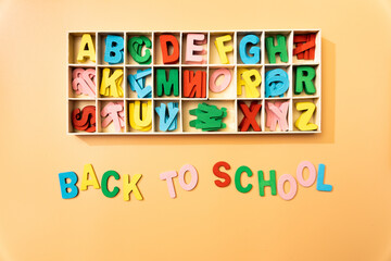 Back to school represented as a concept by wooden color letters over a background
