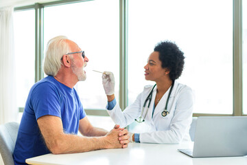 Female doctor examining man throat