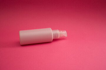 Jar with antiseptic on a pink background