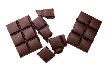 Pieces of tasty black chocolate isolated on white background. Top view