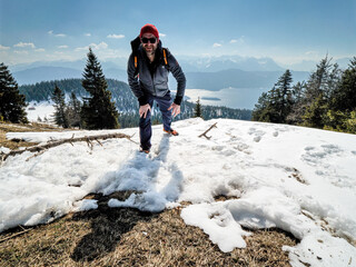 Young and happy Hiker in close up view with Bavarian snow landscape at the background