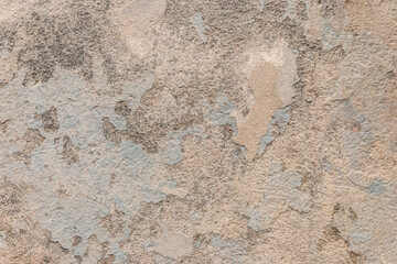 Peeling old plaster with damaged concrete wall cement weathered texture broken background