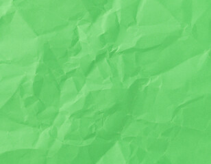 Wrinkled sheet of green paper. Textured backdrop