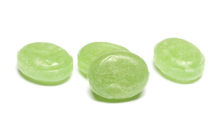 Green hard menthol candies isolated on white  