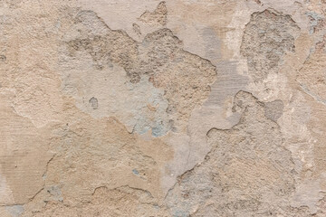 Peeling old plaster with damaged concrete wall cement weathered texture broken background