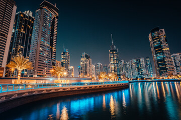 Fototapeta na wymiar Fantastic nighttime skyline with illuminated skyscrapers. Dubai, UAE