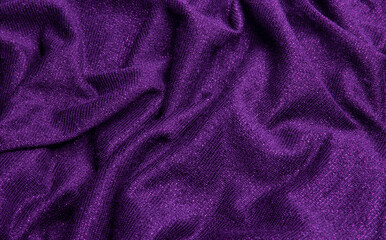Smooth shiny fabric texture with folds and wawes. Close up silk background