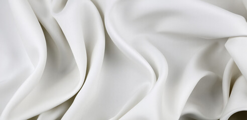 Fototapeta na wymiar Close-up of rippled white silk fabric lines