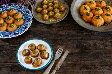 Desserts with syrup and pistachio on the table