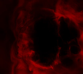 Fototapeta premium Abstract background of chaotically mixing puffs of smoke on a dark background