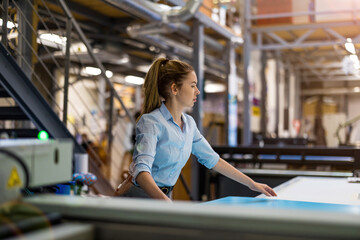 Fototapeta premium Woman working in printing factory 