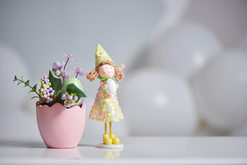 Easter decor in the form of a doll with an egg