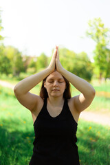 A young girl practices hatha yoga in the fresh air