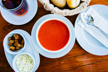 Tomato soup on wooden table in restaurant