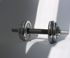 Naklejka na ściany i meble Dumbbell on a white background. Sport and training as a healthy lifestyle