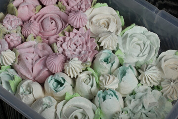 Homemade marshmallows of different shapes and colors. Zephyr flowers.