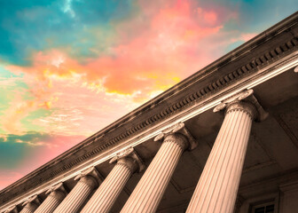 Classical columns on government building with colorful sky - 496190391