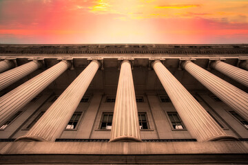 Classical columns on government building with colorful sky - obrazy, fototapety, plakaty