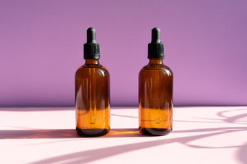 Still life of cosmetic products. Blank, isolated on a powdery pink and lilac background to accommodate your design with sun shadows.