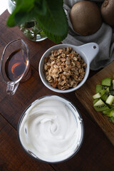 Ingredients to prepare a kiwi parfait or porridge with yogurt and fresh fruit