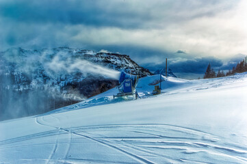 Snow making cannon during work at ski slope in austria.