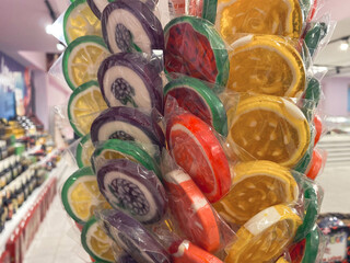 Colorful wrapped lollipops on display, hand made candy, small and big lollipops