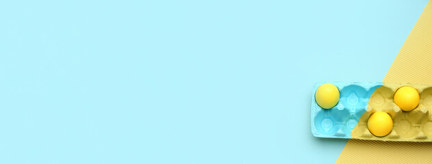 Holder with painted Easter eggs on color background with space for text