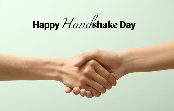 Women shaking hands on light color background. Happy Handshake Day