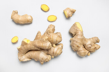 Fresh ginger root on light gray background top view flat lay. Spice for cooking, herbal tea with ginger to boost immunity. Natural organic ginger for health, medicine, protection against colds
