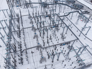 Aerial view of a high voltage electrical substation in winter season.