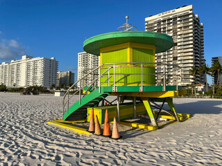Iconic green lifeguard house in Miami Beach. Beautiful blue sky at sunrise.