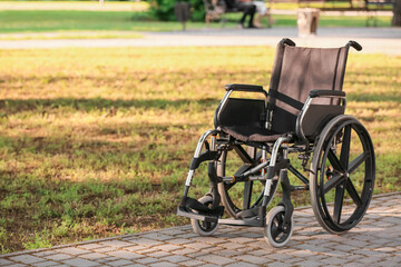 Fototapeta na wymiar Empty modern wheelchair in park