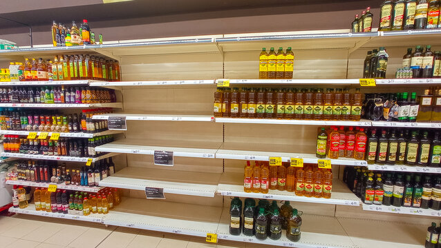 Shortages in supermarkets during the war conflict between Ukraine and Russia, shelves without sunflower oil and little olive oil