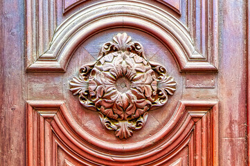 Vintage wooden carved decoration on entrance door.