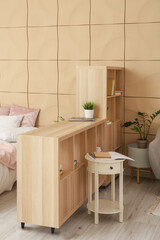 Fototapeta na wymiar Wooden book shelf in interior of modern bedroom