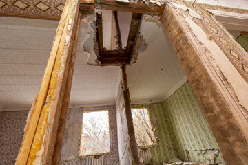 View of the second floor from below through the broken ceiling of the apartment of the house abandoned by the tenants. Destroyed by an explosion residential apartment building.