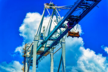 Aerial view over cargo cranes and ships in cargo port of Miami, Florida, USA.
