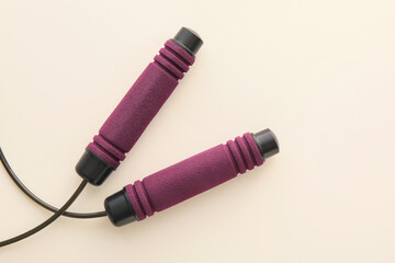 Stylish skipping rope on light background