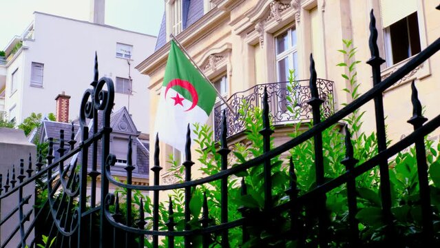 silk national flag of Algeria on facade of building of Consulate General of Algeria in Strasbourg, France, concept of immigration, international relations, tourist visa processing