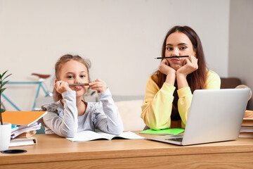 Little girl with tutor having fun during studying at home - obrazy, fototapety, plakaty