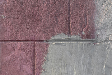 Old wall of concrete blocks in pink paint and cement stains texture background repair construction
