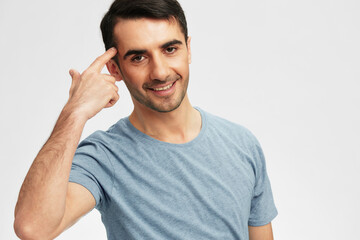 portrait man gesturing with hands blue t-shirt posing light background