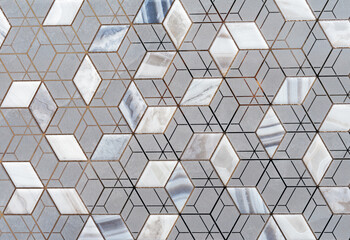 Gray ceramic tiles with a geometric pattern. Tiles with 3D squares.