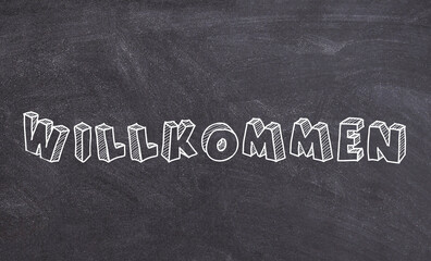 Obraz premium Willkommen sign on chalkboard german welcome