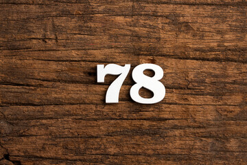 Number 78 - piece on rustic wood background
