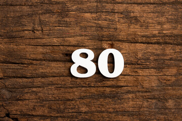 Number 80 - piece on rustic wood background