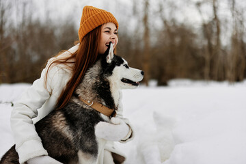 portrait of a woman winter clothes walking the dog in the snow winter holidays