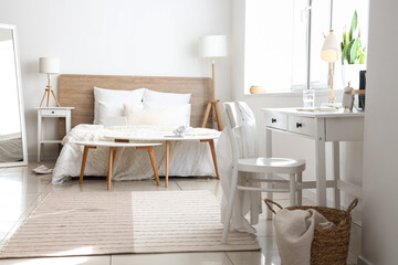 Fototapeta na wymiar Comfortable bed and stylish furniture in room interior