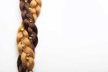 Braided hair with pills on white background